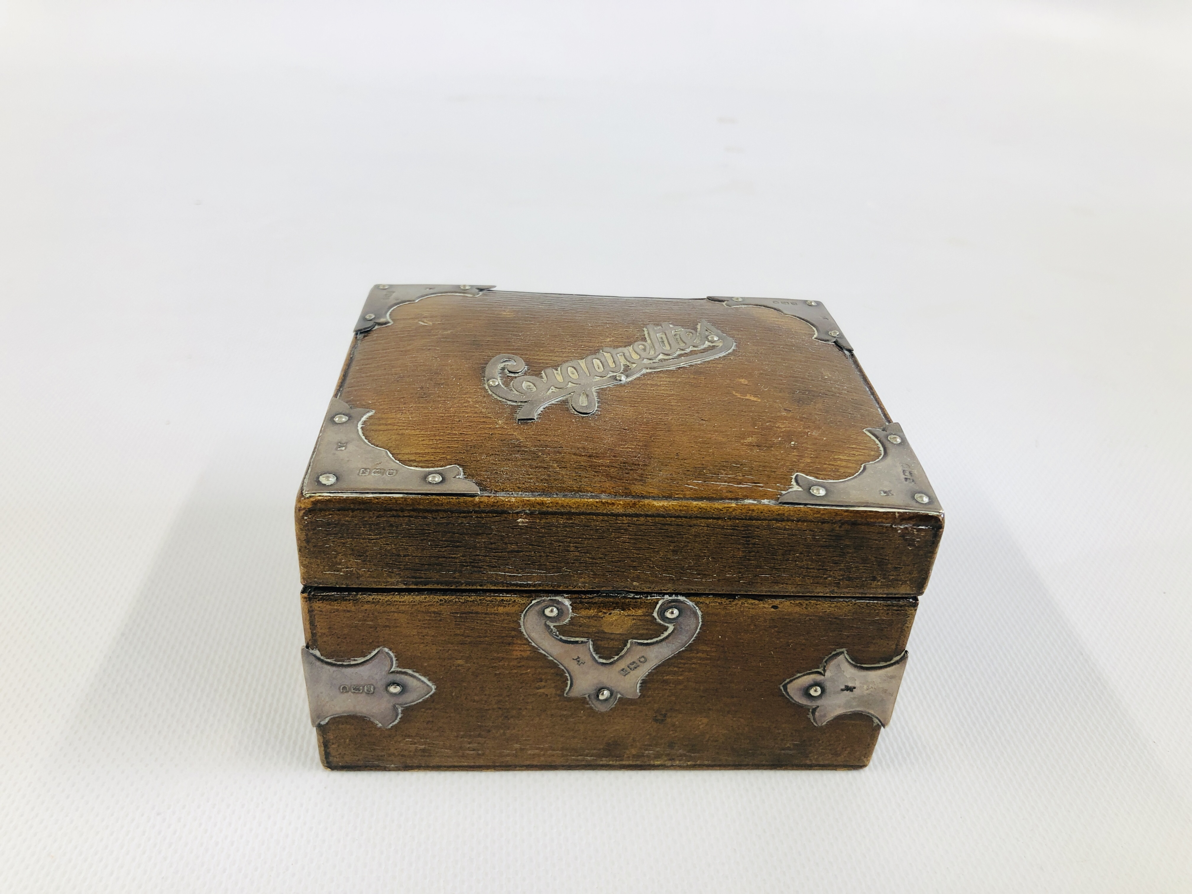 AN ANTIQUE BROWN LEATHER BOUND BOX WITH APPLIED SILVER DETAIL LONDON ASSAY,