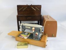 A VINTAGE OAK CANTILEVER SEWING BOX ON WHEELED STAND ALONG WITH CONTENTS TO INCLUDE SEWING