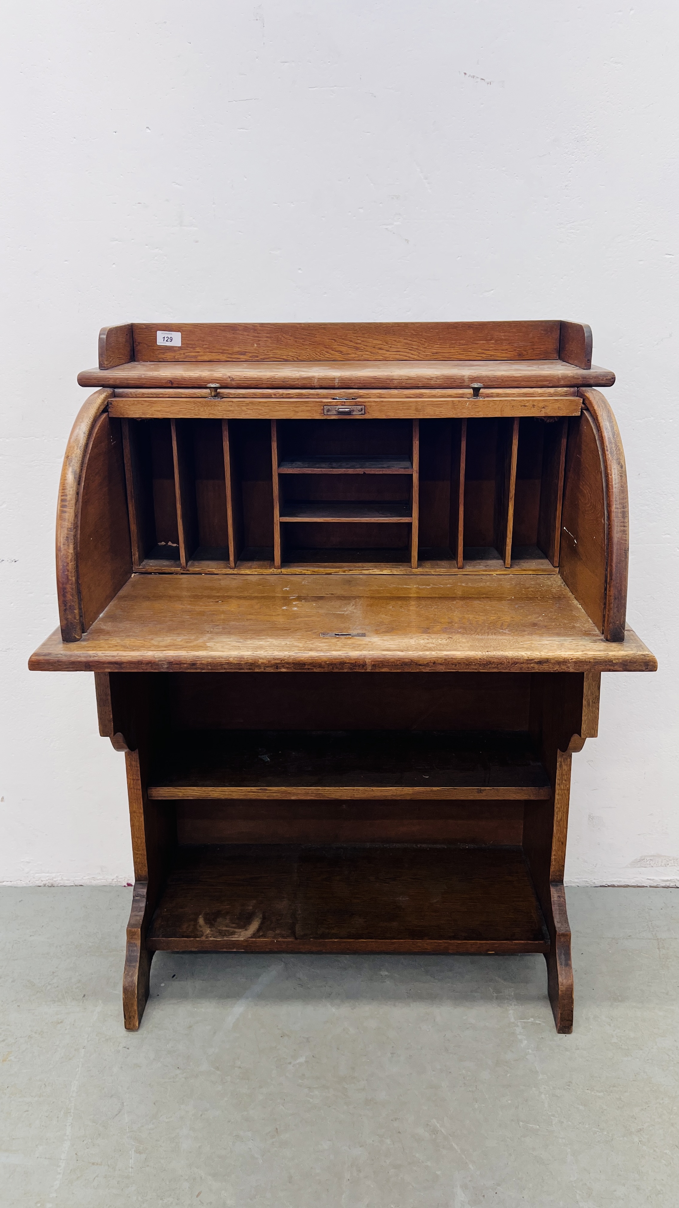 A SMALL OAK ROLL TOP WRITING BUREAU WITH BOOKSHELF TO BASE, W 77CM, D 52CM, H 108CM.