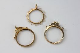A GROUP OF THREE 9CT GOLD PENDANT SOVEREIGN MOUNTS.
