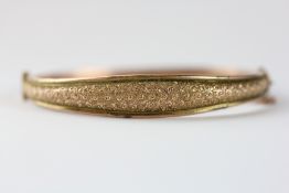 A VINTAGE 9CT GOLD BANGLE AND SAFETY CHAIN.