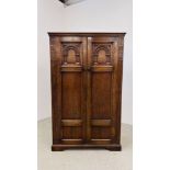 A REPRODUCTION OAK DOUBLE DOOR CUPBOARD, THE DOORS CARVED, W 103CM X D 48CM X H 168CM.