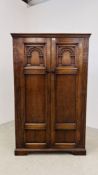 A REPRODUCTION OAK DOUBLE DOOR CUPBOARD, THE DOORS CARVED, W 103CM X D 48CM X H 168CM.