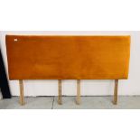 A SUPER KING PADDED HEAD BOARD UPHOLSTERED IN BURNT ORANGE VELOUR.