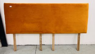 A SUPER KING PADDED HEAD BOARD UPHOLSTERED IN BURNT ORANGE VELOUR.