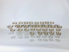 A SET OF GILT RIMMED DRINKING GLASSES, APPROXIMATELY 35.