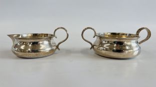 A SILVER CREAM AND SUGAR BOWL OF MATCHING DESIGN