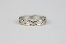 AN INTRICATE OPENWORK RING MARKED PLAT.