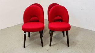 A SET OF FOUR RED UPHOLSTERED DINING CHAIRS.