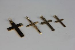 A GROUP OF FOUR 9CT GOLD CROSS PENDANTS.