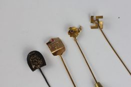 THREE VARIOUS YELLOW METAL STICK PINS, ONE SET WITH A TINY RUBY AND MARKED PONTO IV,