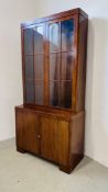 A 1930'S TWO DOOR MAHOGANY BOOKCASE ON CUPBOARD BASE - W 92CM. D 40CM. H 184CM.