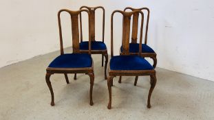 A SET OF FOUR OAK FRAMED HIGH BACK DINING CHAIRS WITH BLUE VELVET SEATS.