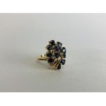 AN ELABORATE DIAMOND AND SAPPHIRE RING MARKED 14K.