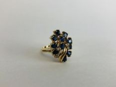 AN ELABORATE DIAMOND AND SAPPHIRE RING MARKED 14K.