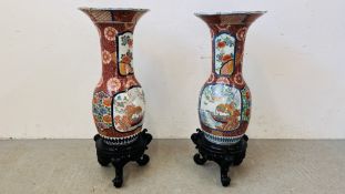 A PAIR OF LARGE AND IMPRESSIVE ANTIQUE JAPANESE VASES ON HARDWOOD CARVED STANDS,