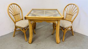 A SQUARE BAMBOO FRAMED GLASS TOPED DINING TABLE ALONG WITH A PAIR OF BAMBOO FRAMED CHAIRS.