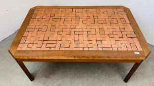 A LARGE OAK COFFEE TABLE WITH COPPER BLOCK WOOD EFFECT INSERT TO TOP BEARING ULFERTS LABEL,