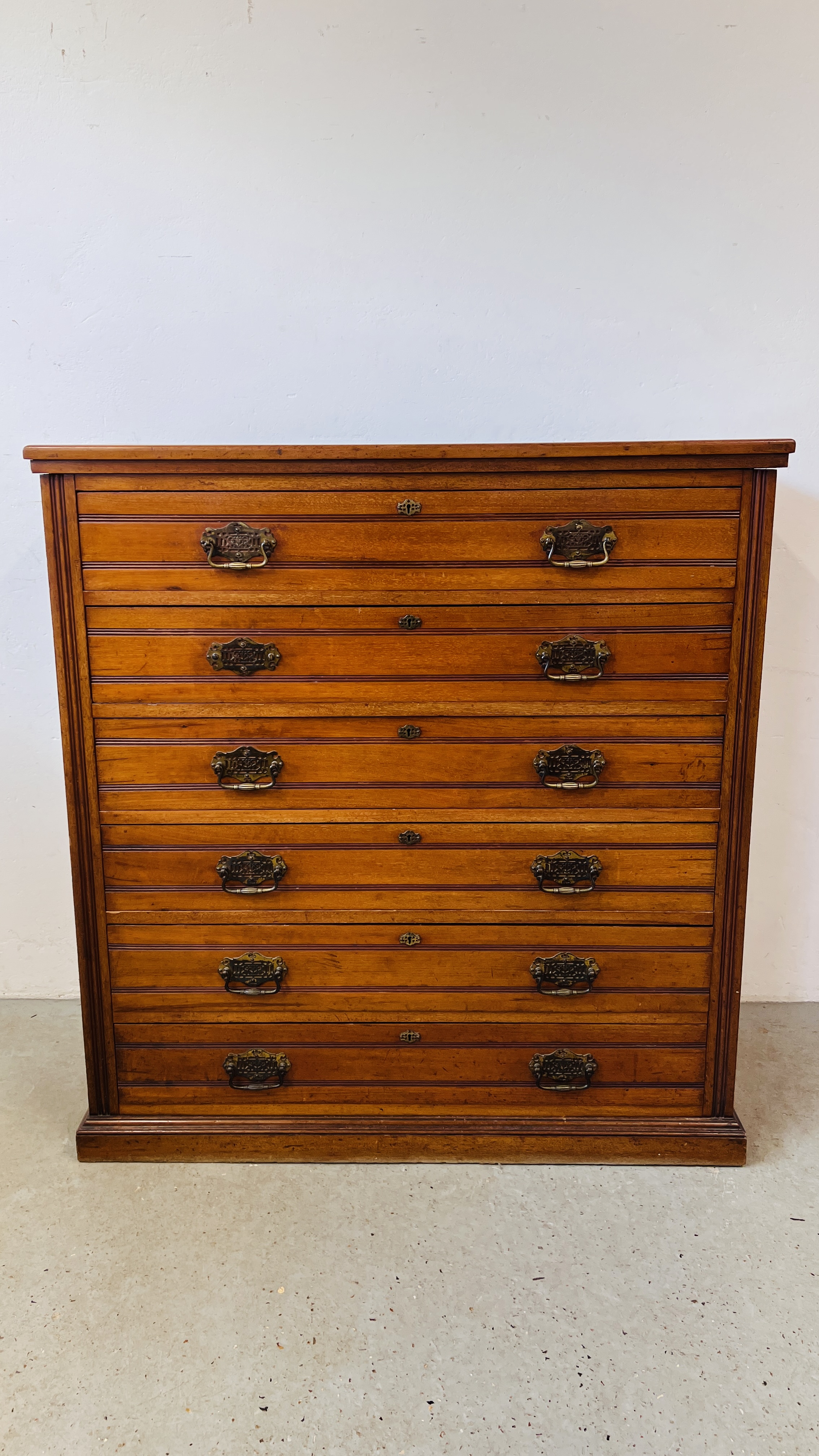 AN EDWARDIAN AMERICAN WALNUT 6 DRAWER CHEST WITH BRASS PLATE HANDLES W 112CM. D 46CM. H 118CM.