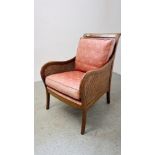 A REPRODUCTION BERGERE WORK ARMCHAIR WITH CUSHIONS.