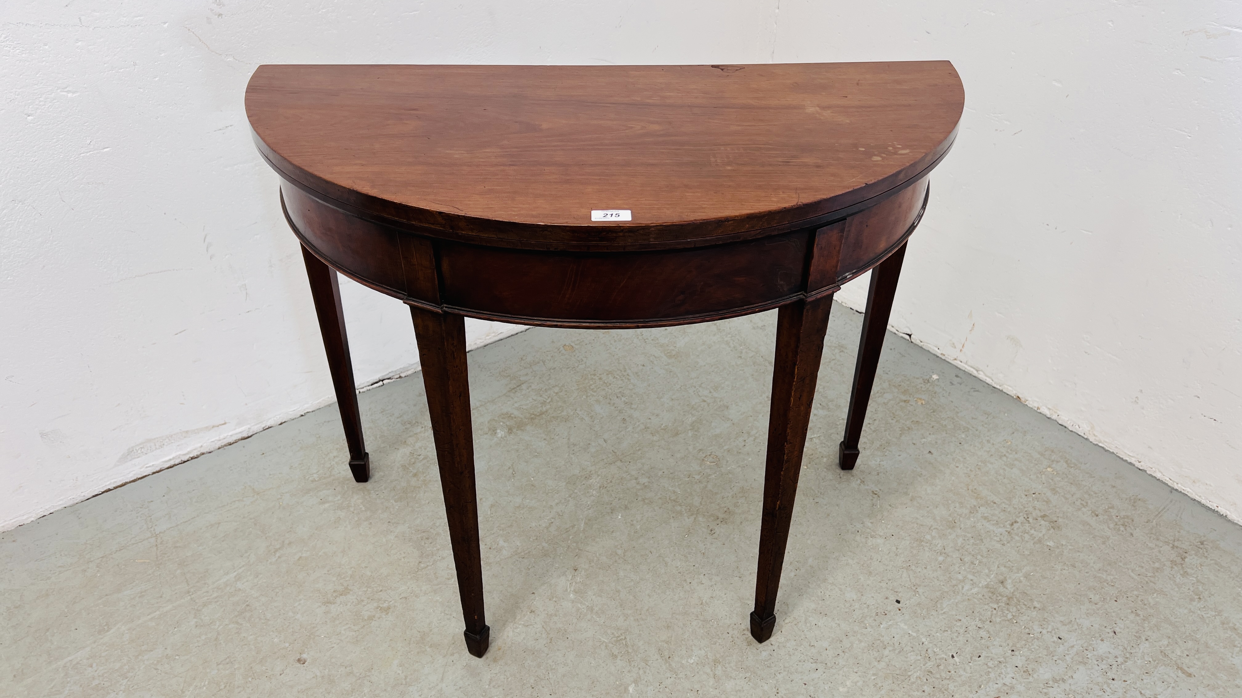 A MAHOGANY DEMI LUNE FOLDING TOP SIDE TABLE WITH GATELEG ACTION, ON SQUARE TAPERED LEG - WIDTH 92CM.