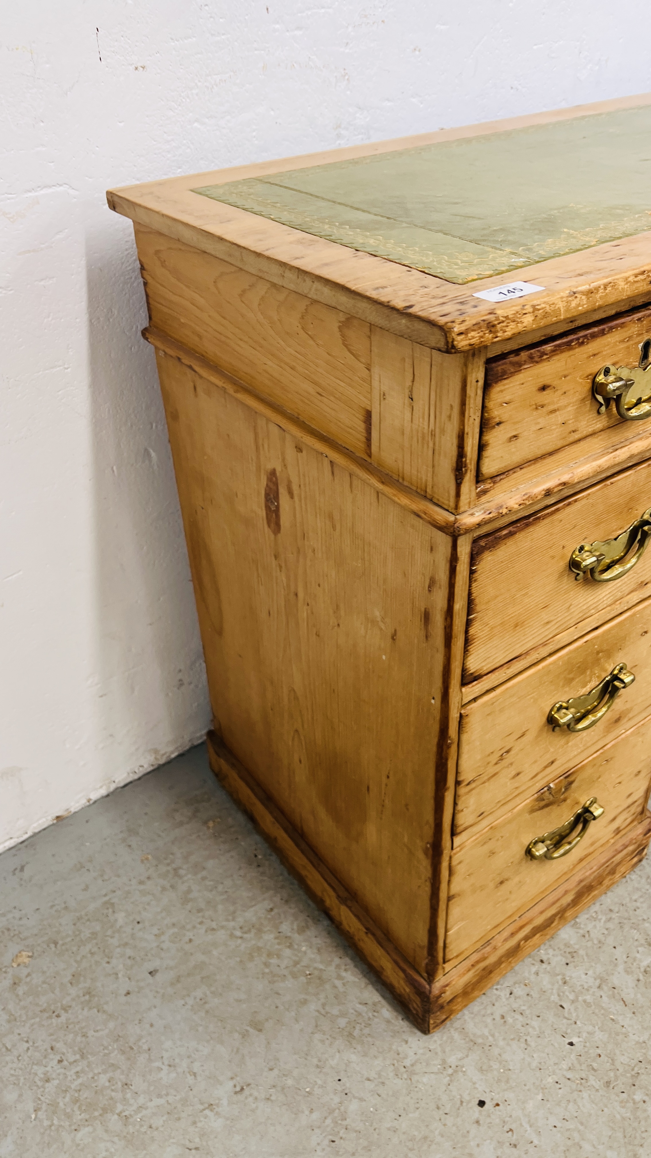 AN ANTIQUE WAXED PINE NINE DRAWER KNEEHOLE DESK WITH TOOLED LEATHER INSET TOP. - Image 10 of 11