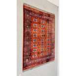 A MAINLY RED BACKED BOKHARA-STYLE RUG 130CM. X 180CM. BEARING MAKERS SEAL.