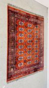 A MAINLY RED BACKED BOKHARA-STYLE RUG 130CM. X 180CM. BEARING MAKERS SEAL.