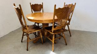 A MODERN HARDWOOD SINGLE PEDESTAL CIRCULAR EXTENDING DINING TABLE AND FOUR MATCHING DINING CHAIRS