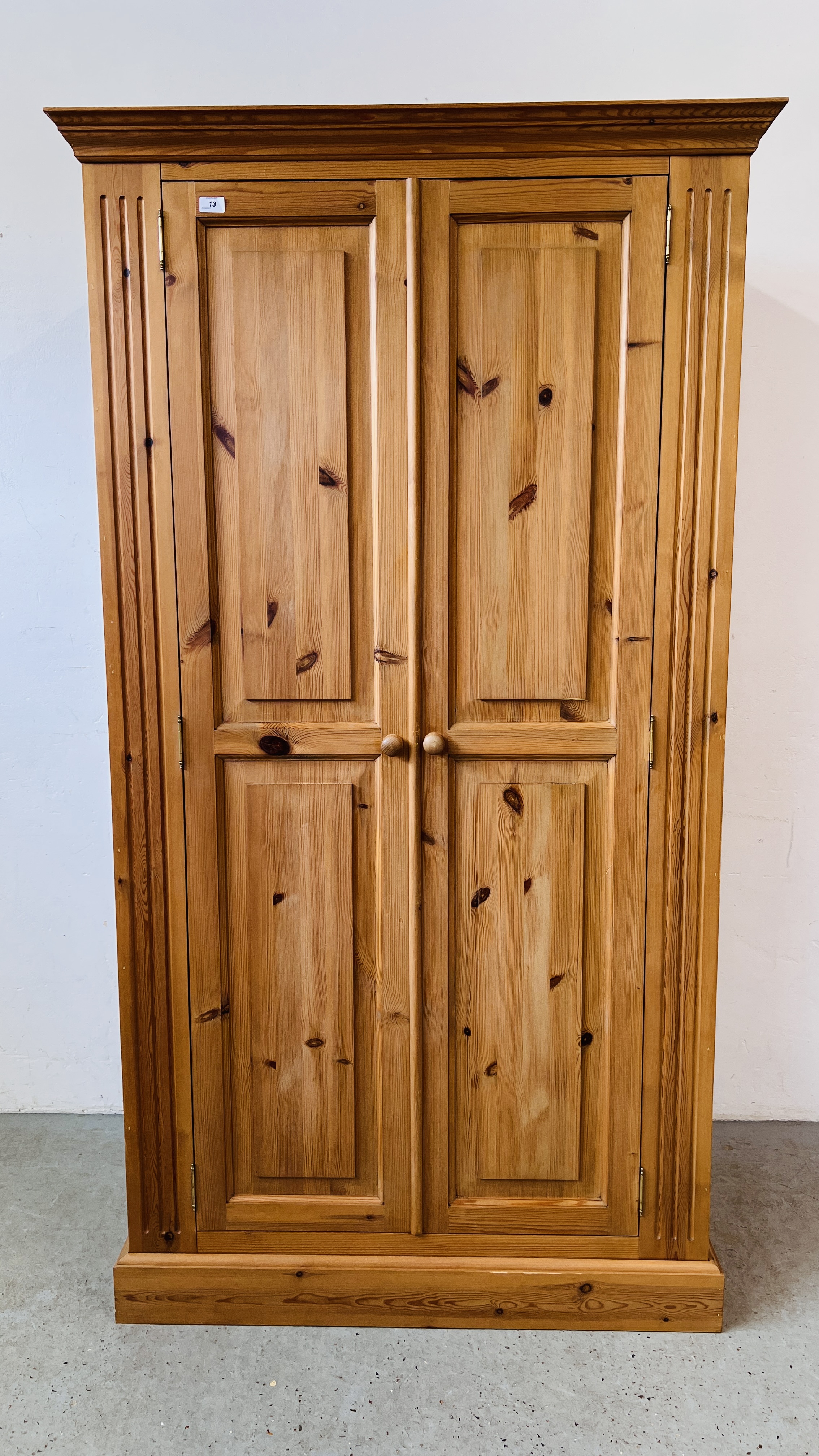 A GOOD QUALITY WAXED PINE TWO DOOR WARDROBE, W 108CM, D 60CM, H 196CM.