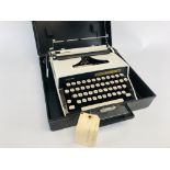 A RETRO REMINGTON MONARCH - 1 PORTABLE TYPEWRITER IN CARRY CASE.