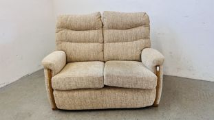 A MODERN TWO SEATER FAWN UPHOLSTERED SOFA WIDTH 130CM.