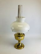 A BRASSED ALADIN TABLE OIL LAMP WITH OPAGUE GLASS SHADE.