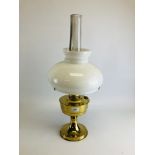 A BRASSED ALADIN TABLE OIL LAMP WITH OPAGUE GLASS SHADE.
