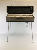 A VINTAGE ORGAN MARKED "LORENZO" IN FITTED HARDCASE WITH LEGS - COLLECTORS ITEM ONLY.