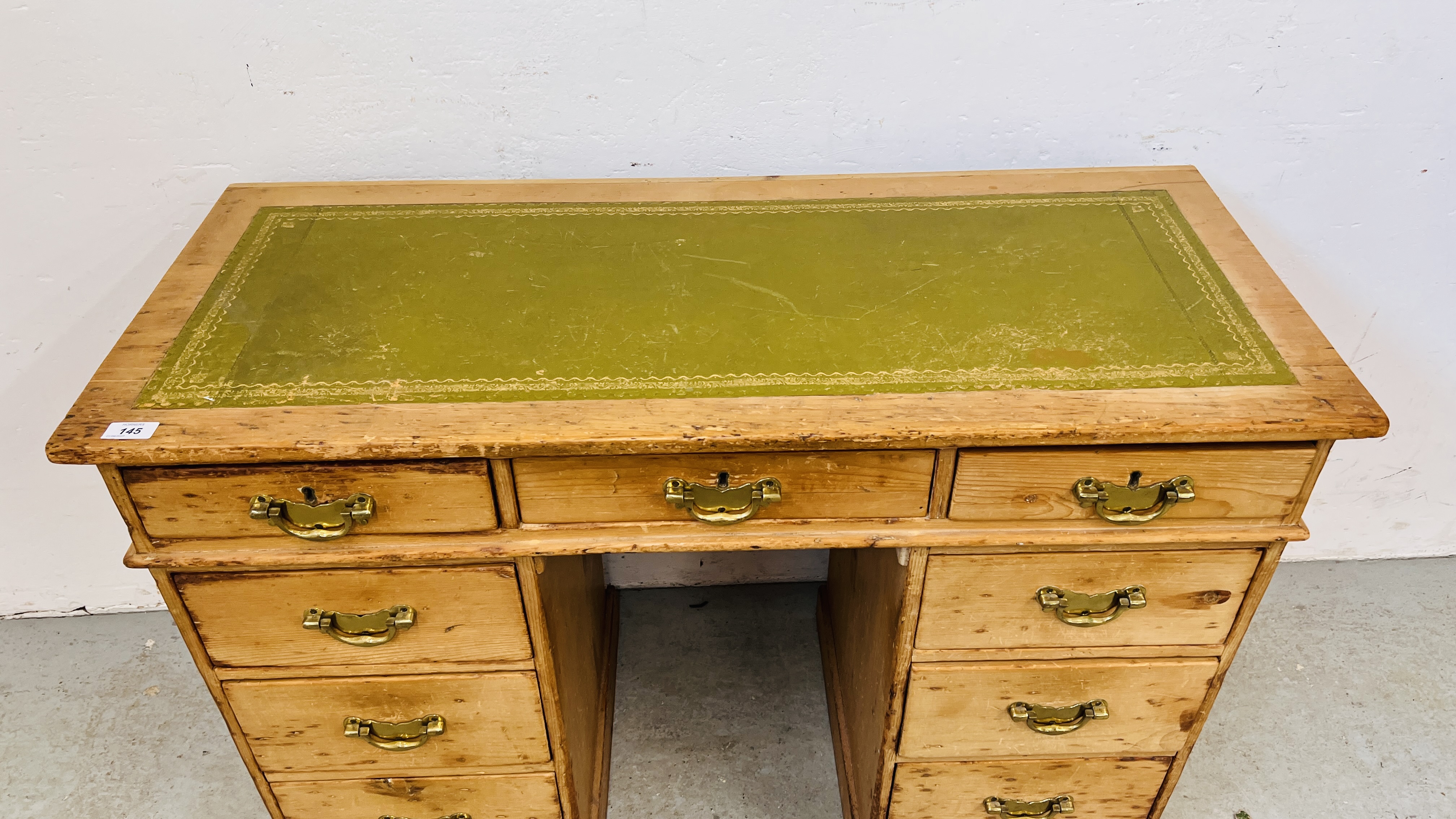 AN ANTIQUE WAXED PINE NINE DRAWER KNEEHOLE DESK WITH TOOLED LEATHER INSET TOP. - Image 2 of 11