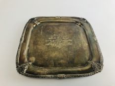 A SILVER SALVER OF SQUARE FORM WITH RAISED SHELL CORNERS WITH PRESENTATION INSCRIPTION ON QUADRUPLE