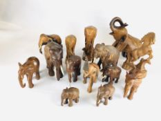 A GROUP OF 13 CARVED HARDWOOD ELEPHANT STUDIES OF VARYING SIZES AND A REARING HORSE EXAMPLE.