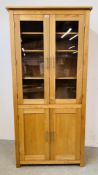 A MODERN LIGHT OAK GLAZED CABINET WITH SHELVED INTERIOR AND CUPBOARD TO BASE. W 93CM. D 36CM.