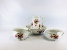 A VINTAGE FLORAL DECORATED WASH JUG AND BOWL ALONG WITH TWO MATCHING CHAMBER POTS.