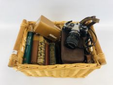 A TWO HANDLED WICKER BASKET AND CONTENTS TO INCLUDE BOOKS JEW SÜSS, BLACK BEAUTY BY ANNA SEWELL ETC.