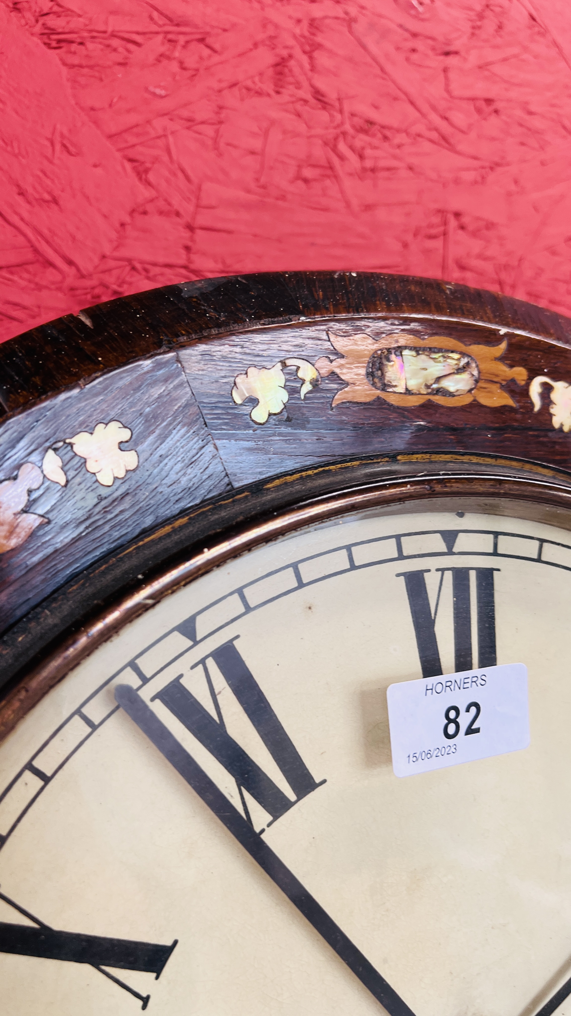 AN ANTIQUE GINGERBREAD STYLE MAHOGANY WALL CLOCK WITH MOTHER OF PEARL INLAY. - Image 4 of 5