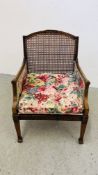 A BERGERE WORK CHAIR.