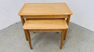 TWO MODERN GRADUATED LIGHT OAK OCCASIONAL TABLES (LARGEST 69 X 42CM).