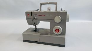 A SINGER HEAVY DUTY ELECTRIC SEWING MACHINE AND FOOT PEDAL - SOLD AS SEEN.