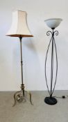 A SOLID BRASS STANDARD LAMP ON TRI LEGS ALONG WITH A MODERN BLACK FINISHED UPLIGHTER - SOLD AS SEEN.