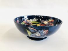 A MOORCROFT BOWL OF BLUE GLAZED AND FLOWER DESIGN, DIAMETER 27CM.