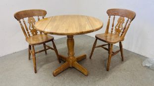 LIMED OAK DROP FLAP PEDESTAL BREAKFAST TABLE AND TWO CHAIRS.