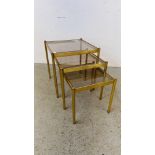 A NEST OF 3 GRADUATED BRASS FINISH TABLES WITH GLASS INSERTS 44 X 44CM.