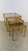 A NEST OF 3 GRADUATED BRASS FINISH TABLES WITH GLASS INSERTS 44 X 44CM.